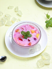 sop buah or fruit soup is indonesian fruit cocktail ice made from various diced fruits mixed with ice cubes, condensed milk and red syrup. popular food for breakfasting