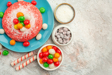 top view delicious pink cake with colorful candies on white background rainbow color dessert cake candy