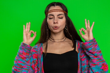 Keep calm down, relax, inner balance. Young woman breathes deeply with mudra gesture, eyes closed,...