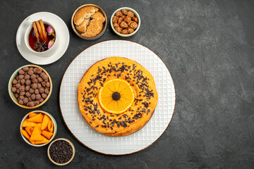 top view delicious sweet pie with orange slices and cup of tea on dark background cookie pie biscuit cake dessert tea