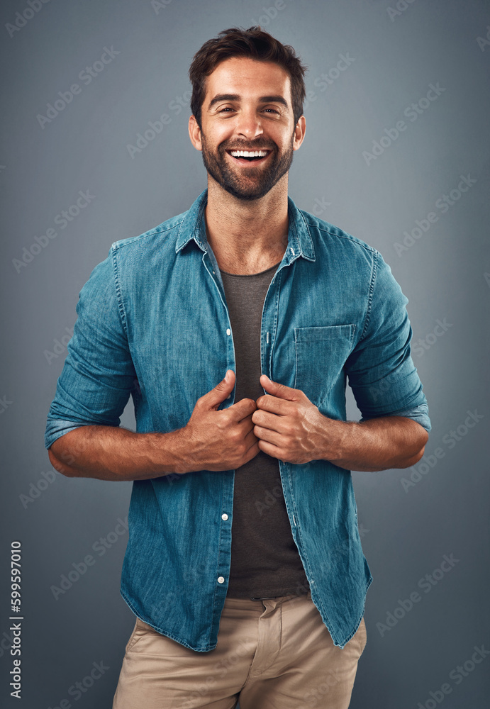 Poster making casual look as cool as ever. studio shot of a handsome and happy young man posing against a g