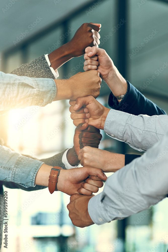 Poster your team can be a tower of strength. a group of unrecognizable businesspeople stacking fists.