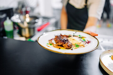 Chef cooking Roasted Duck breast fillets with mashed potato on restaurant kitchen