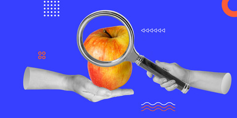 Apple behind magnifying glass in hand. Quality Control. Magnifying glass revealing intricate...