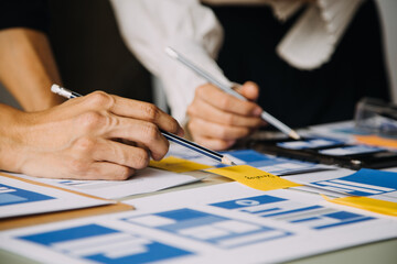 Close up ux developer and ui designer brainstorming about mobile app interface wireframe design on...