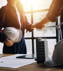 Professional Mechanical Engineer team Working on Personal Computer at Metal lathe industrial manufacturing factory. Engineer Operating lathe Machinery. Product quality Inspection