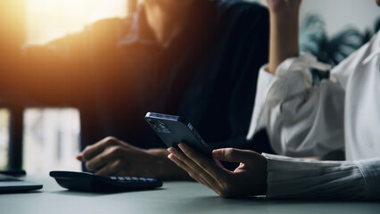 Entrepreneur Asian businessman and businesswoman discussing new business project in tablet in modern Meeting In Modern Office, Asian business casual concept.