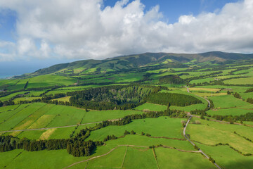 Fototapeta na wymiar Aerial view of the landscapes on Sao Miguel Island, green farmland and volcanic mountains and lakes, Azores, Portugal