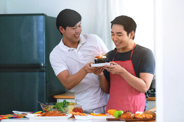 LGBTQ couples have a romantic moments together, Asian couple celebrate birthday with cake together at home, thank you kiss for the birthday cake