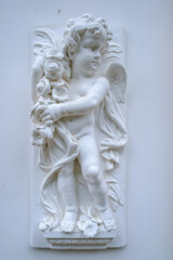 Childlike Angel Figure on a House Wall