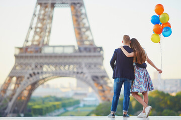 Couple with colorful balloons near the Eiffel tower