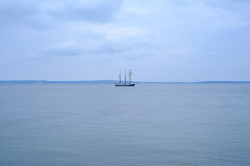 Fototapeta na wymiar Lonely Distant Sailing Ship