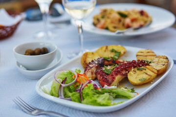 Grilled octopus with baked potatoes