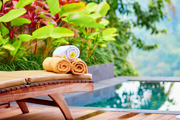 Towels with frangipani flowers in Balinese spa