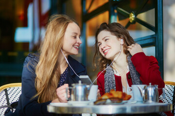 Two young girls in Parisian outdoor cafe