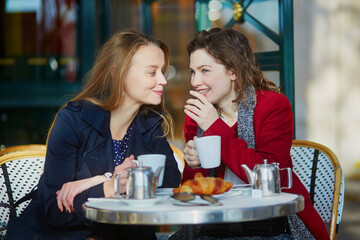 Two young girls in Parisian outdoor cafe