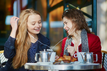 Two young girls in Parisian outdoor cafe