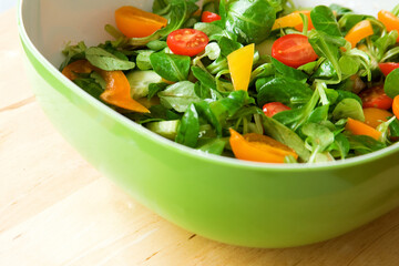 Eat healthy! Fresh vegetable salad served in a green salad bowl