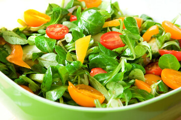 Eat healthy! Fresh vegetable salad served in a green salad bowl