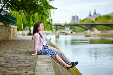 Couple is sitting on the embankment