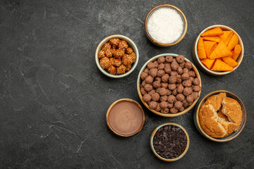 top view sweet nuts with cocoa flakes and cips on dark background snack milk meal breakfast color