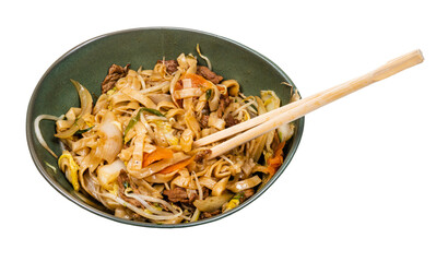 vietnamese Sao Udon fried in wok with vegetables and beef pieces in bowl with chopsticks cutout on white background