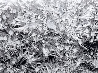 natural frost pattern on window glass closeup on cold winter day