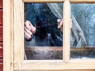 installation of window pane in wooden frame in rural house close up