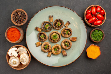 top view tasty mushrooms dish with tomatoes and seasonings on dark background dish dinner meal cooking mushroom