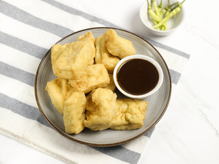 Tahu Petis is a typical Semarang snack, javanese traditional snack. Fried Tofu eaten with petis or processed food made from black shrimp paste smeared or inserted in the middle of tofu