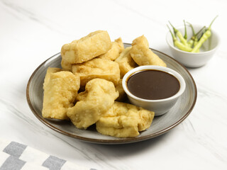 Tahu Petis is a typical Semarang snack, javanese traditional snack. Fried Tofu eaten with petis or processed food made from black shrimp paste smeared or inserted in the middle of tofu
