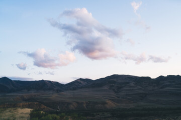 Cloudy blue sky over mountainous terrain during daytime