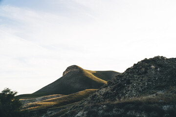 Mountain ridge with crushed stones under cloudy sky