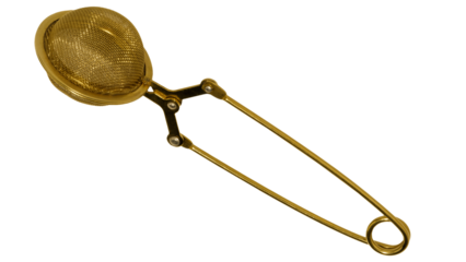 Tea strainer isolated on transparent background. Gold metal tea infuser. Metal tea brew mesh.