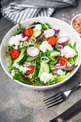 salad cheese green leaves vegetable radish, tomato, cucumber meal food snack on the table copy space food background rustic top view 