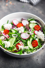 salad cheese green leaves vegetable radish, tomato, cucumber meal food snack on the table copy space food background rustic top view 