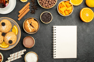 top view yummy cookies with orange slices and cup of tea on dark background cake pie sugar dessert biscuit tea