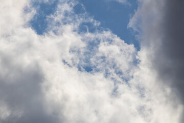 Looking up at white clouds against blue sky