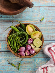 Ingredients for making Sambel Ijo, a typical chili sauce from Padang, West Sumatra consisting of green chilies, green tomatoes, shallots, garlic and a little lime juice