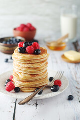 Pancakes with berries in rustic style