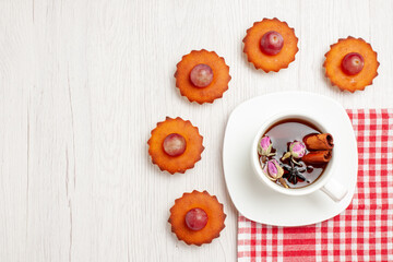 top view yummy little cakes with cup of tea on white background fruit tea dessert cookie biscuit cake pie