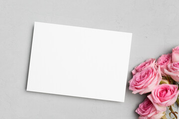Blank invitation or greeting card mockup with fresh roses flowers, mock up with copy space