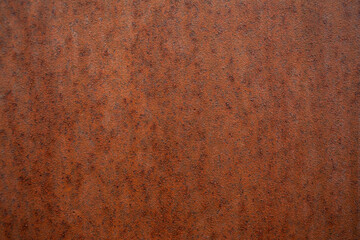 Full frame, close up of a big old flower pot, warm rust color surface.