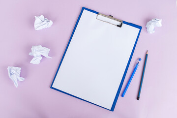 Top view of a set of blue stationery as a template with a place to copy on a purple table.