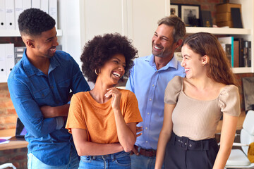 Portrait Of Multi-Cultural Business Team Standing Together In Office