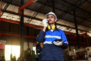 Portraits of male workers, technicians, and professional engineers. holding a walkie-talkie and a tablet