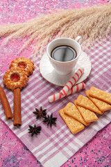front view cup of tea with cinnamon cookies and crackers on the pink desk biscuit sugar sweet bake