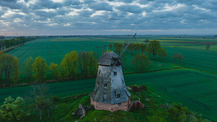 
An old Dutch windmill in the village of Palczewo in Żuławy, Poland. Spring morning. Drone view.