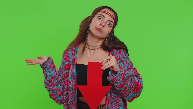 Upset woman showing red arrow pointing down, concept of downgrade, unsuccessful business, fall of stock market money exchange rate bankruptcy fail. Girl isolated on chroma key background, green screen