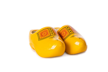 Typical dutch yellow wooden shoes on a white background